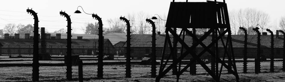 A stark black-and-white photo of a Nazi concentration camp.